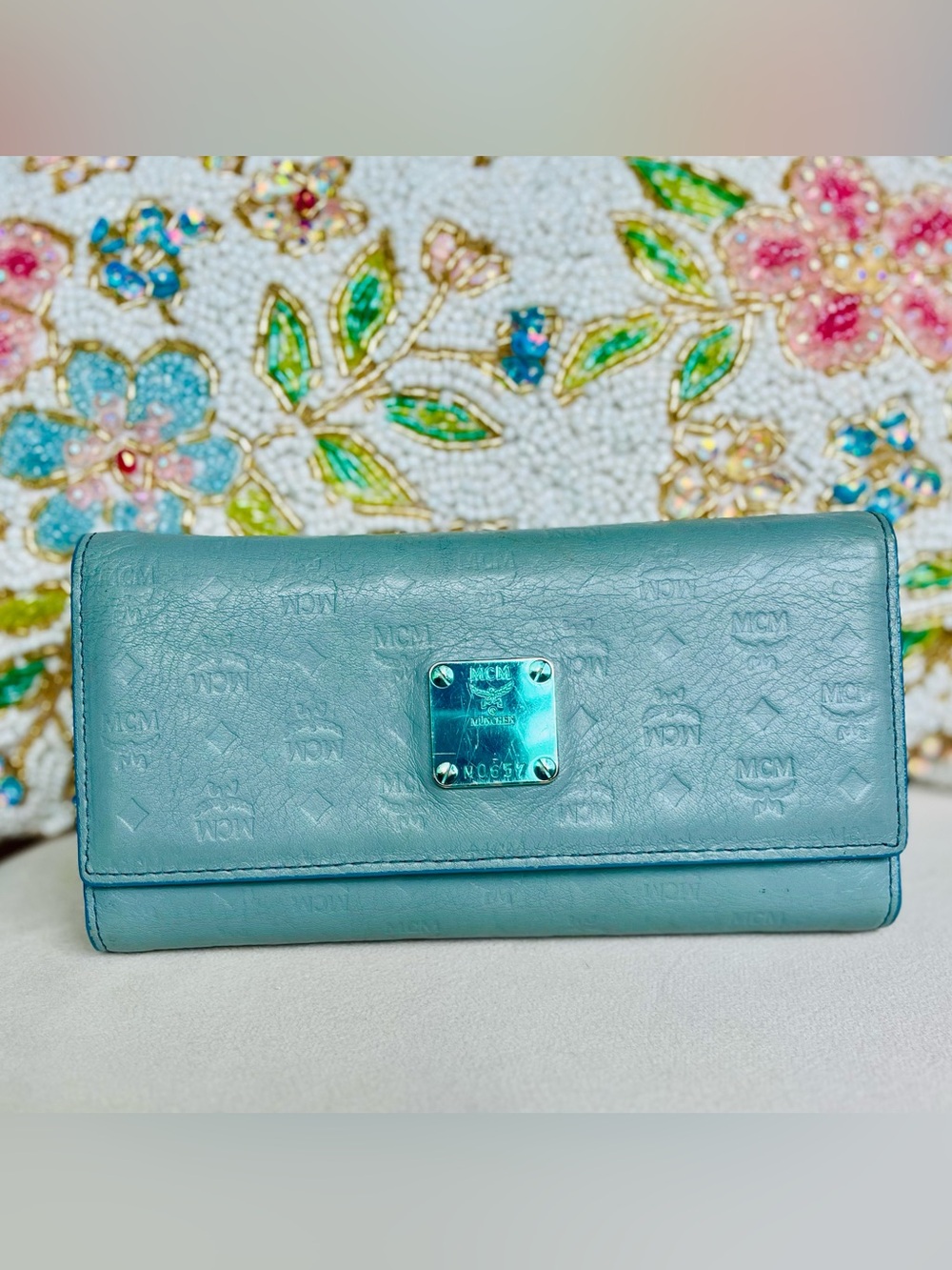 MCM Munchen trifold wallet in new condition except scratches on name plate.
